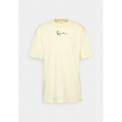 Kobiety T_SHIRT_TOP | Karl Kani SMALL SIGNATURE LOGO TEE UNISEX  - T-shirt z nadrukiem - light yellow/jasnożółty - UU89528